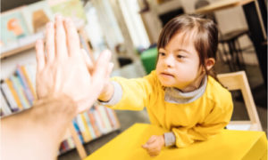 The child gives a high five.